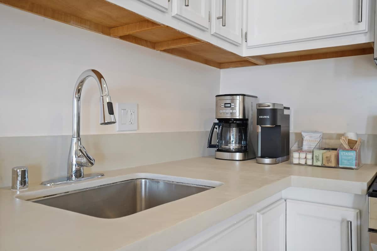 Coffee station ready to kickstart your mornings, complete with an espresso machine and drip coffee maker.