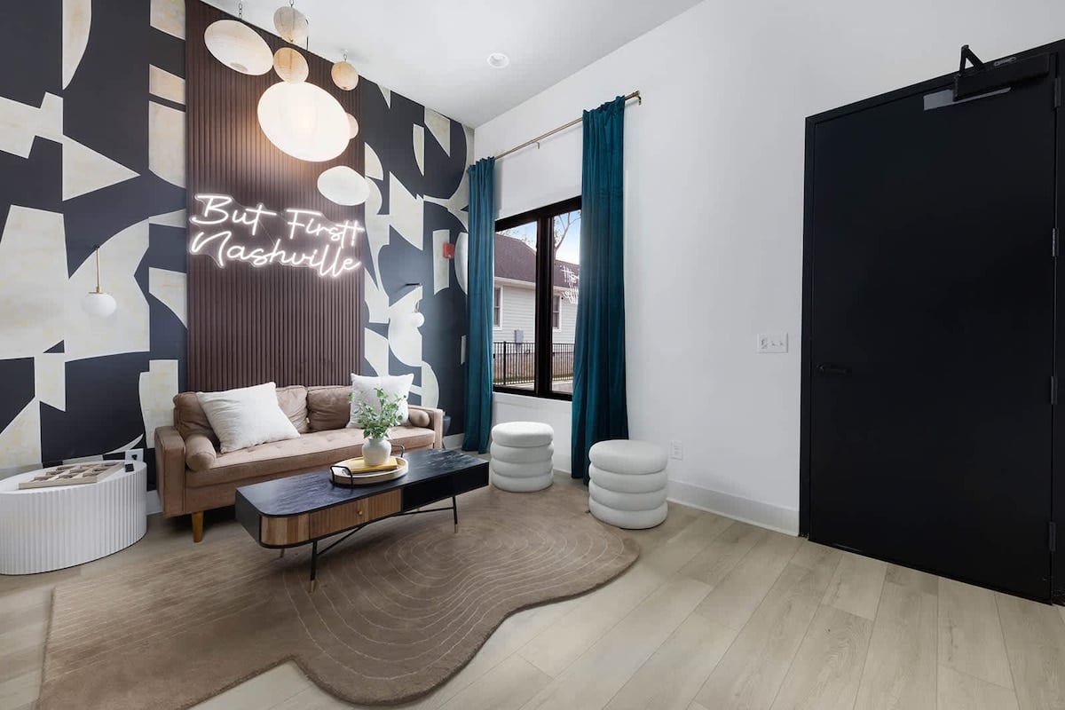 The living room's cozy vibe and bold design, highlighted by a feature wall, create the perfect backdrop for selfies.