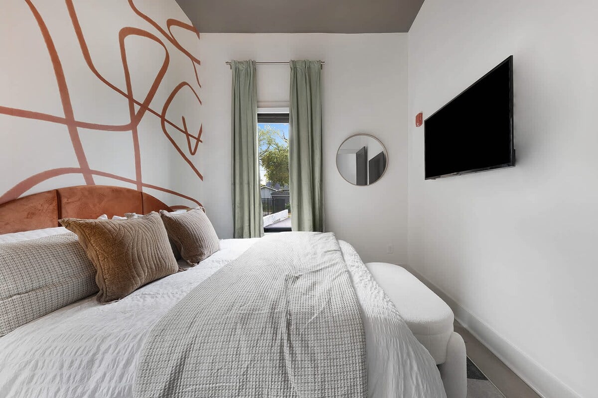 Featuring a luxurious king-sized bed and a wall-mounted smart TV, the bedroom is ideal for unwinding and enjoying your favorite shows and movies.