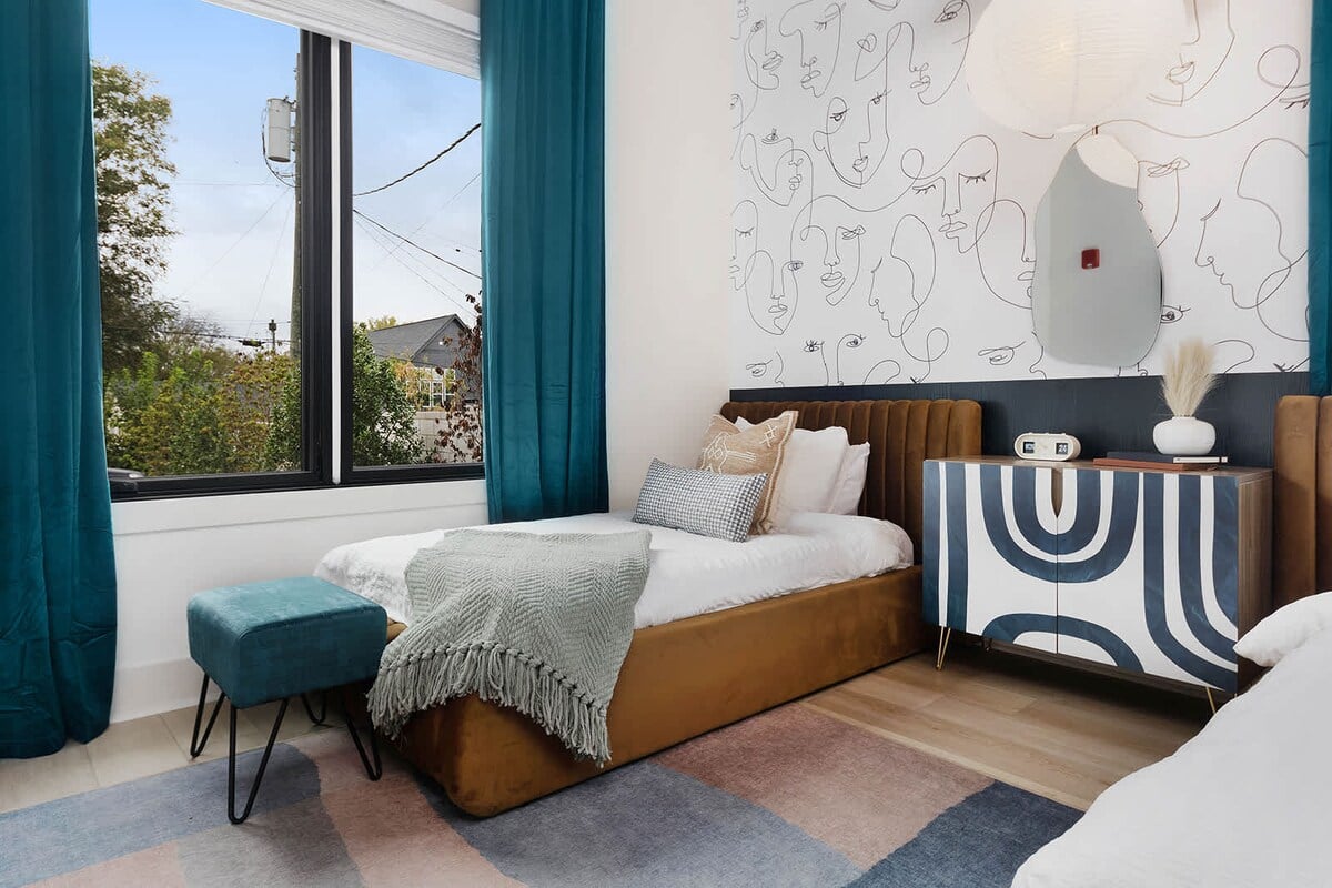 The guest bedroom, featuring two twin beds, offers a playful setting for a memorable sleepover.