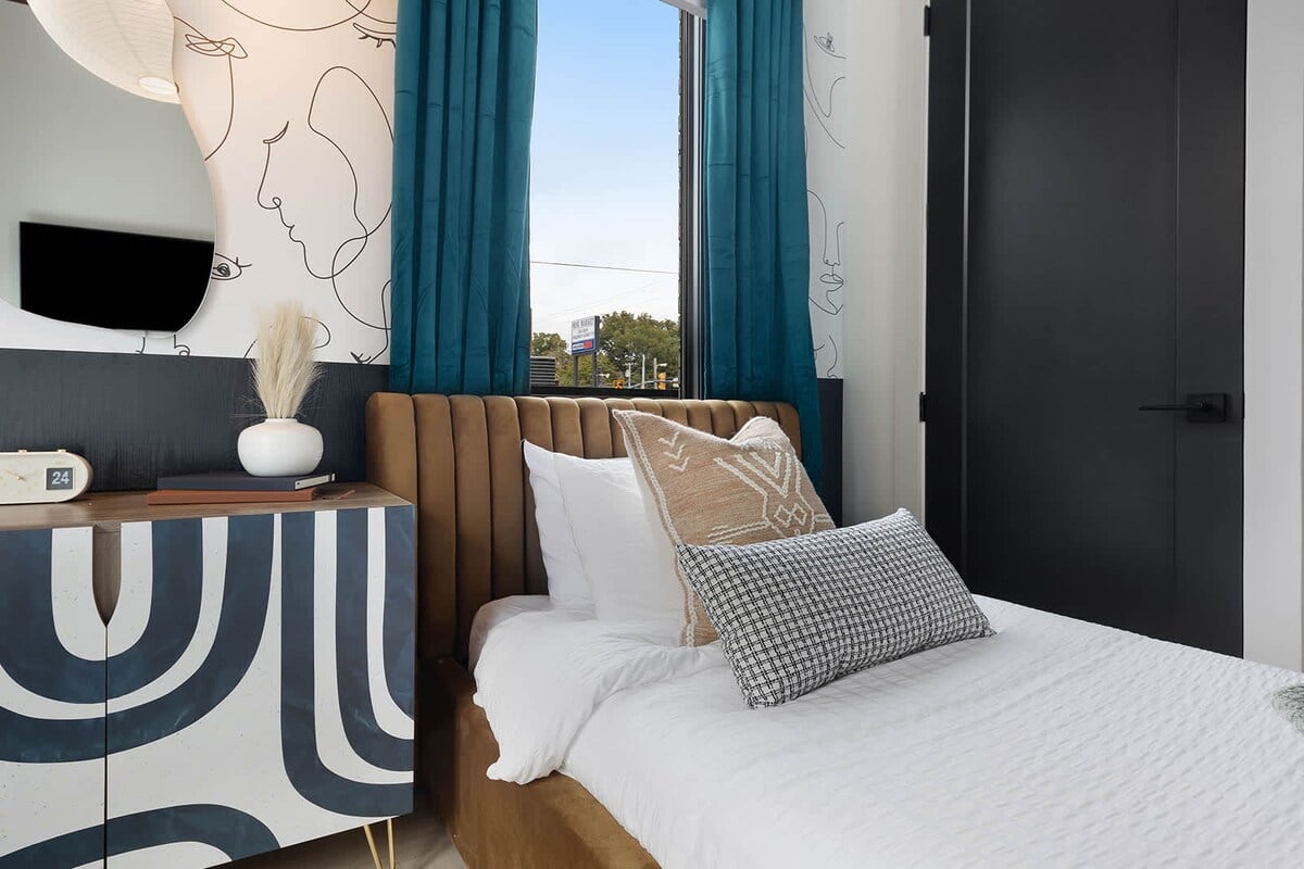 The mix of earthy tones and textures on the twin beds sets a relaxed and cozy atmosphere.