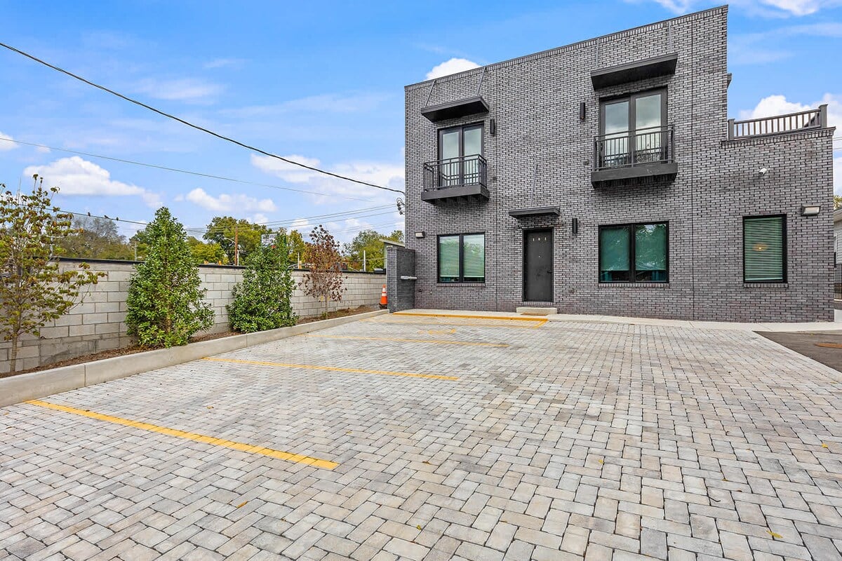 There are 5 parking spaces available, along with a designated handicap space, in the shared parking lot behind the apartment.