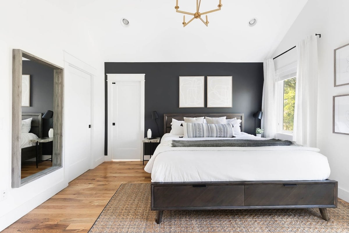 The second-floor master bedroom boasts a large king bed and vaulted ceilings.
