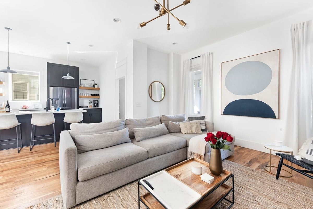 The open layout between the living room and kitchen invites everyone to join in the conversation.