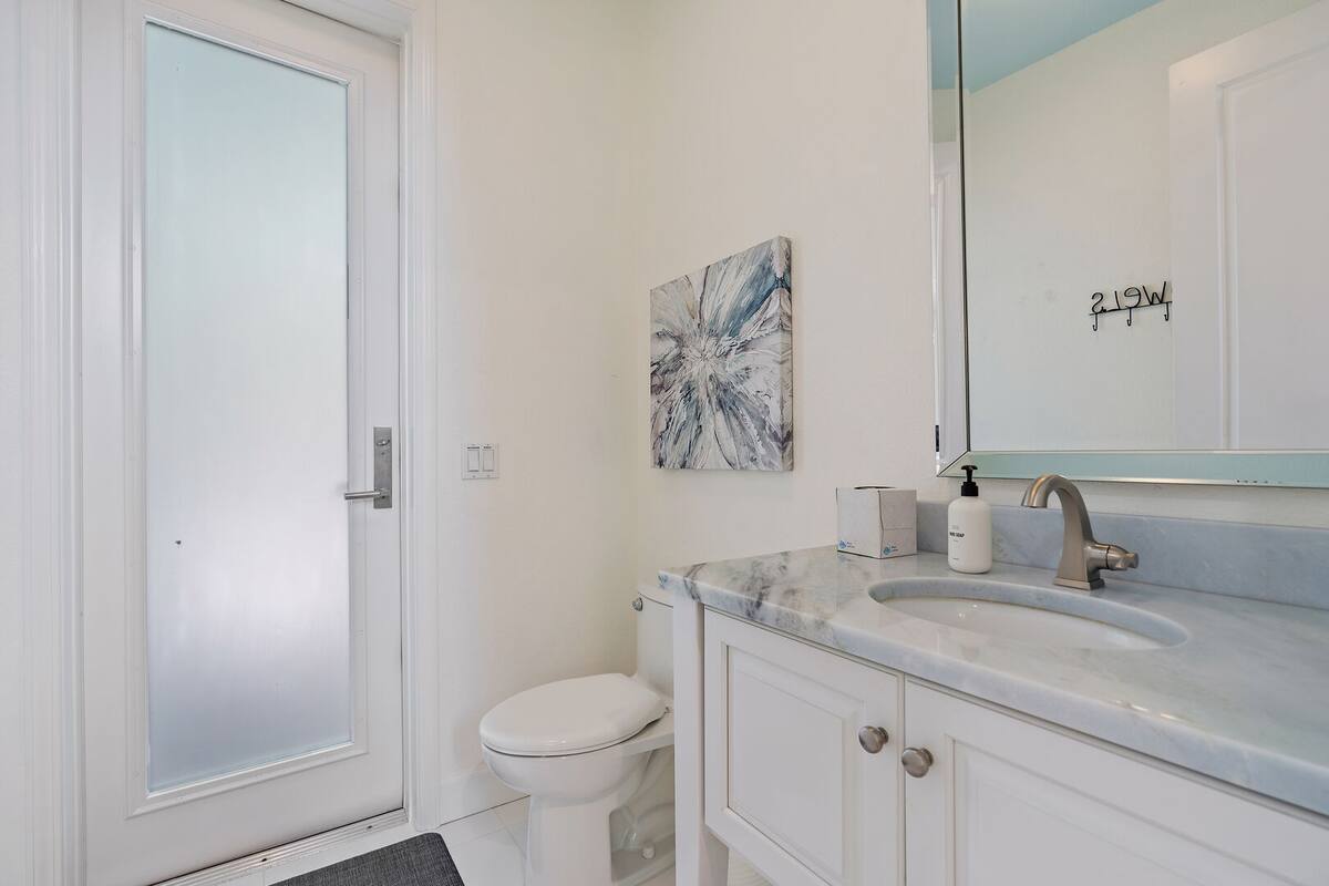 Half bath located on the main floor next to the kitchen with exterior door leading to your patio and pool area. Great washroom for the pool space.