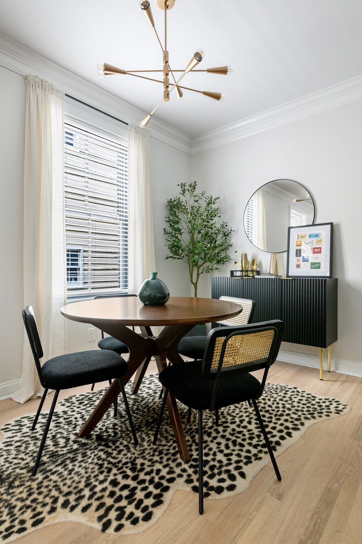 CAPTION:
Discover the "Property" in Charleston, showcasing mid-century modern elegance with its sleek furnishings and minimalist charm. The inviting atmosphere is enhanced by a soft, neutral color palette complemented by bold black accents. A stylish sputnik chandelier illuminates the dining area, exuding a sophisticated and welcoming ambiance. Ideal for travelers seeking a refined aesthetic and modern luxury, this property offers an inspiring retreat with attention to design detail.