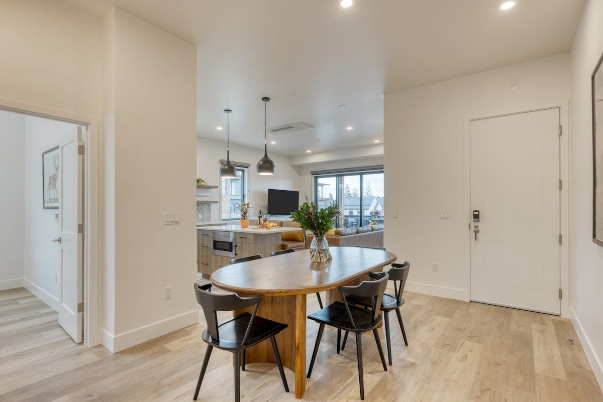 Wide view of the dining and kitchen space highlighting the bright, airy layout.