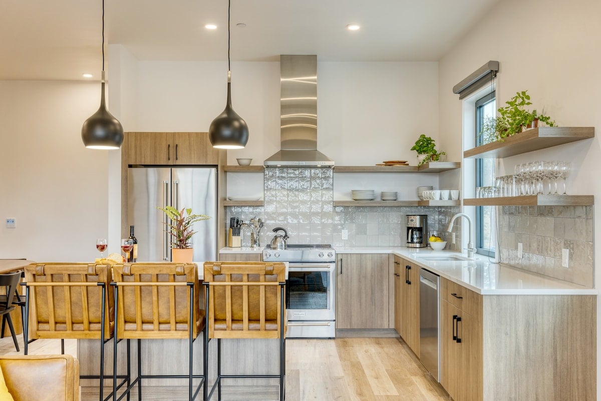 Full kitchen view showcasing the range hood and contemporary fixtures.