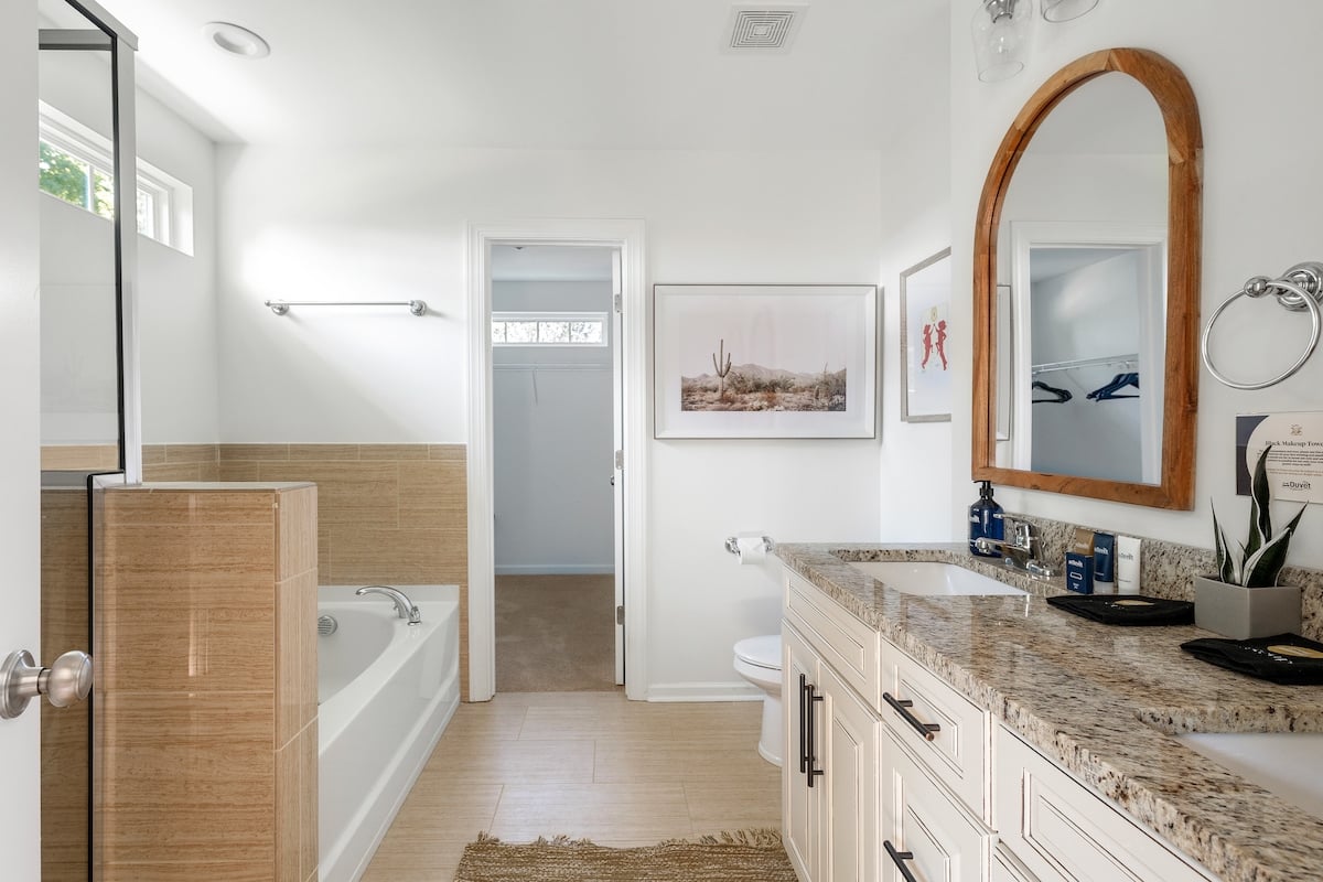 The ensuite bathroom with standing shower and soaking bathtub