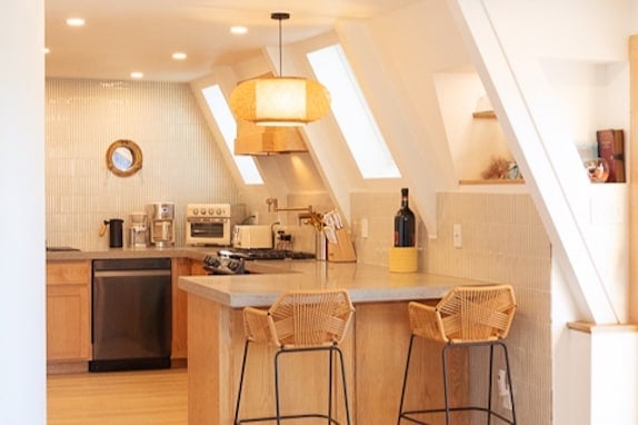 Large bar top with custom poured concrete kitchen countertops. Great for an informal eating area.