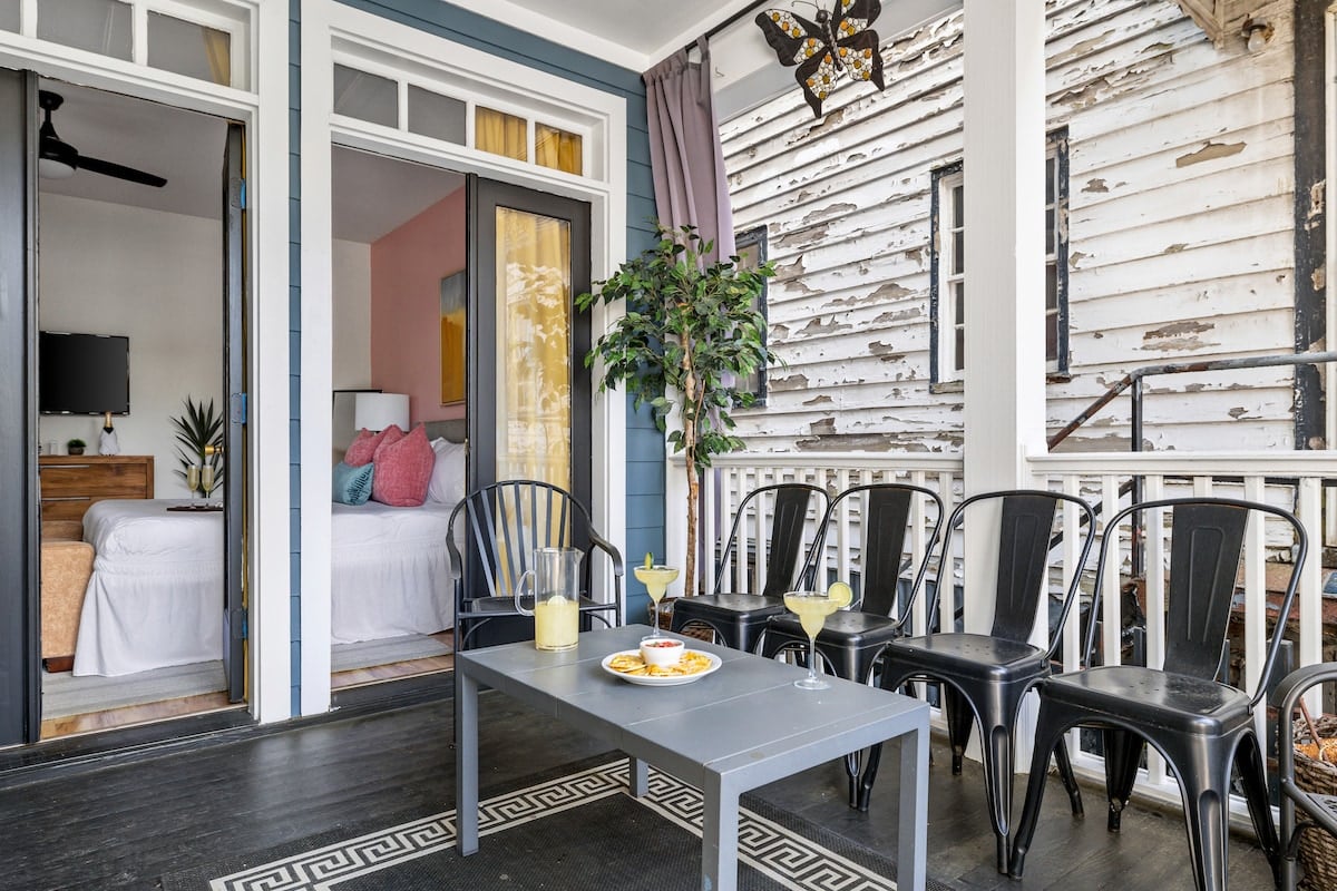 **CAPTION:** Nestled in Charleston, US, "Property" exudes classic Southern charm with its rustic yet refined architectural style. The weathered wood siding adds a touch of historic allure, while the cozy patio invites relaxation. The color palette combines soft pastels and natural tones, creating a warm and inviting atmosphere. With elegant white trims and chic outdoor furnishings, this luxury travel destination captivates travelers seeking an authentic Southern experience.