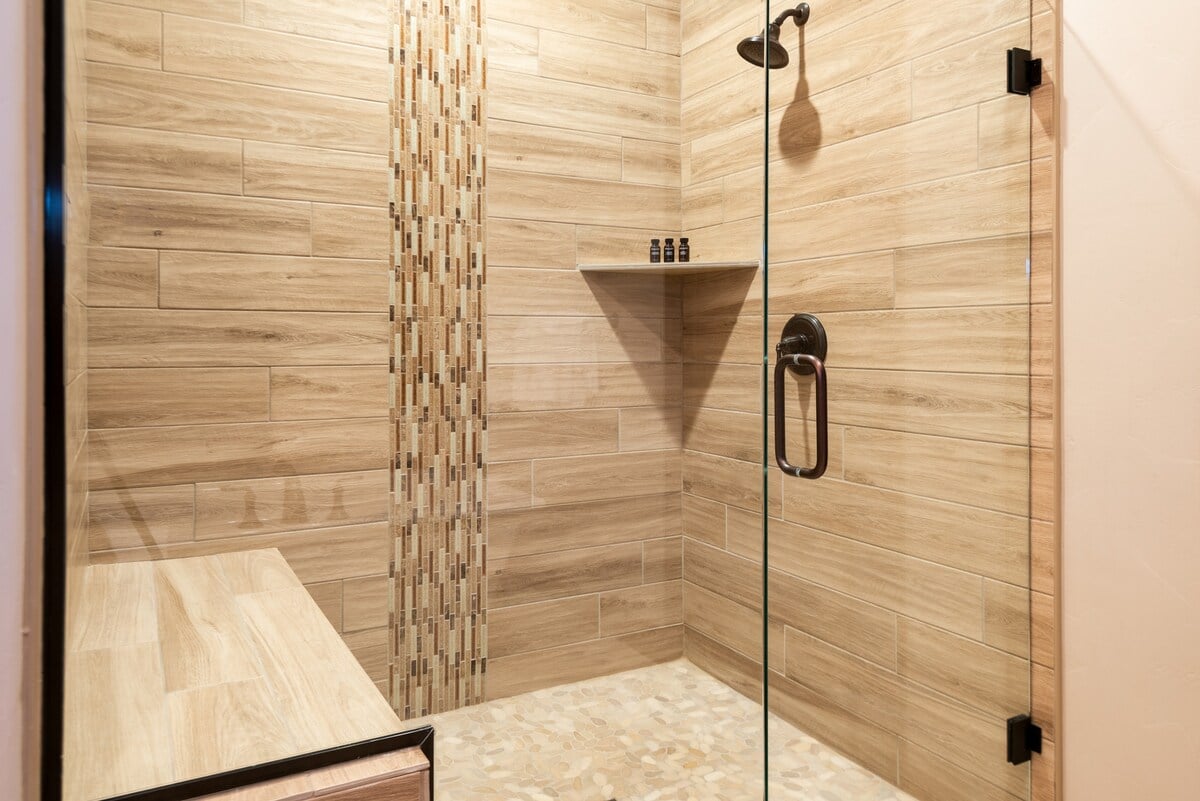 Large walk-in shower with a built-in seat.