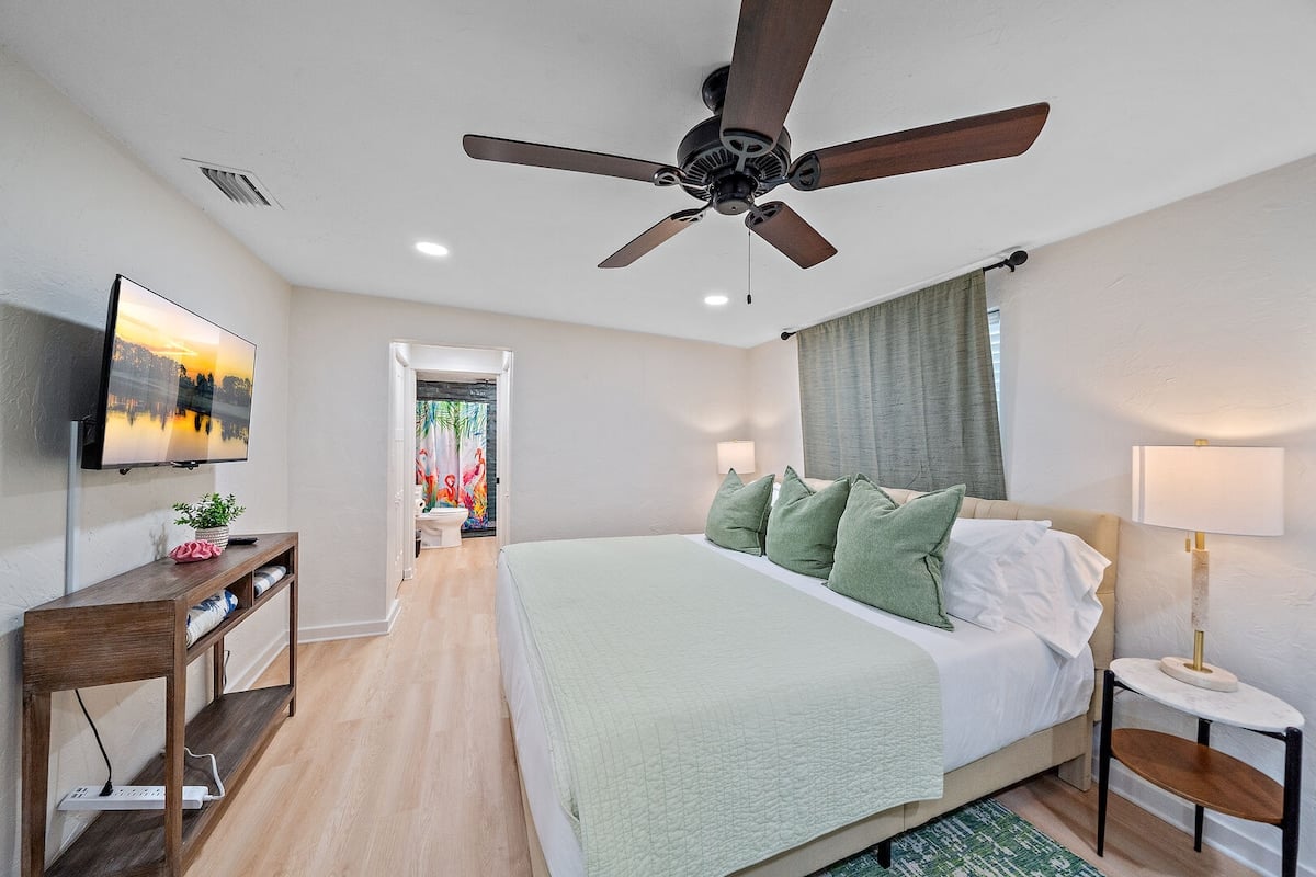 House 1: Bedroom 1 - King Bed, a smart TV, and a Twin day bed.