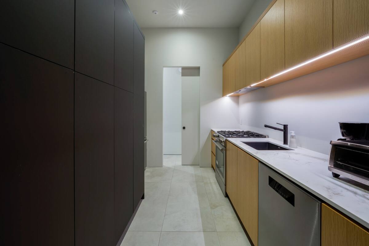 Cook in style with a gourmet kitchen equipped with top-of-the-line appliances and sleek, modern finishes.
