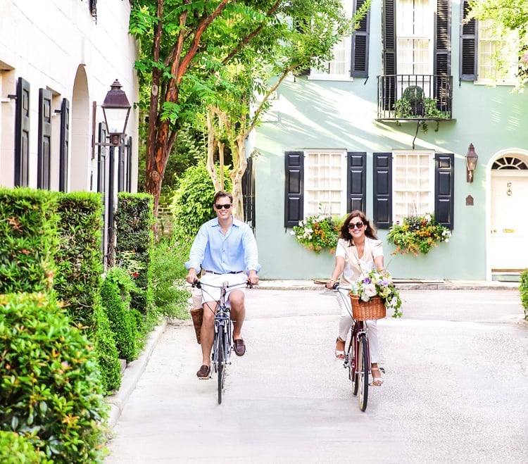 Couples cruise past Charleston's iconic Rainbow Row on complimentary bicycles, discovering the city's pastel-painted treasures and cobblestone charm at their own leisurely pace.