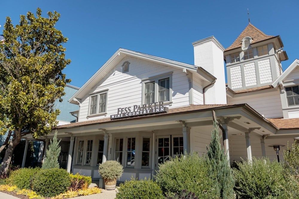 White clapboard siding and a welcoming wraparound porch evoke Old West charm at this historic inn, where rustic elegance meets wine country sophistication.