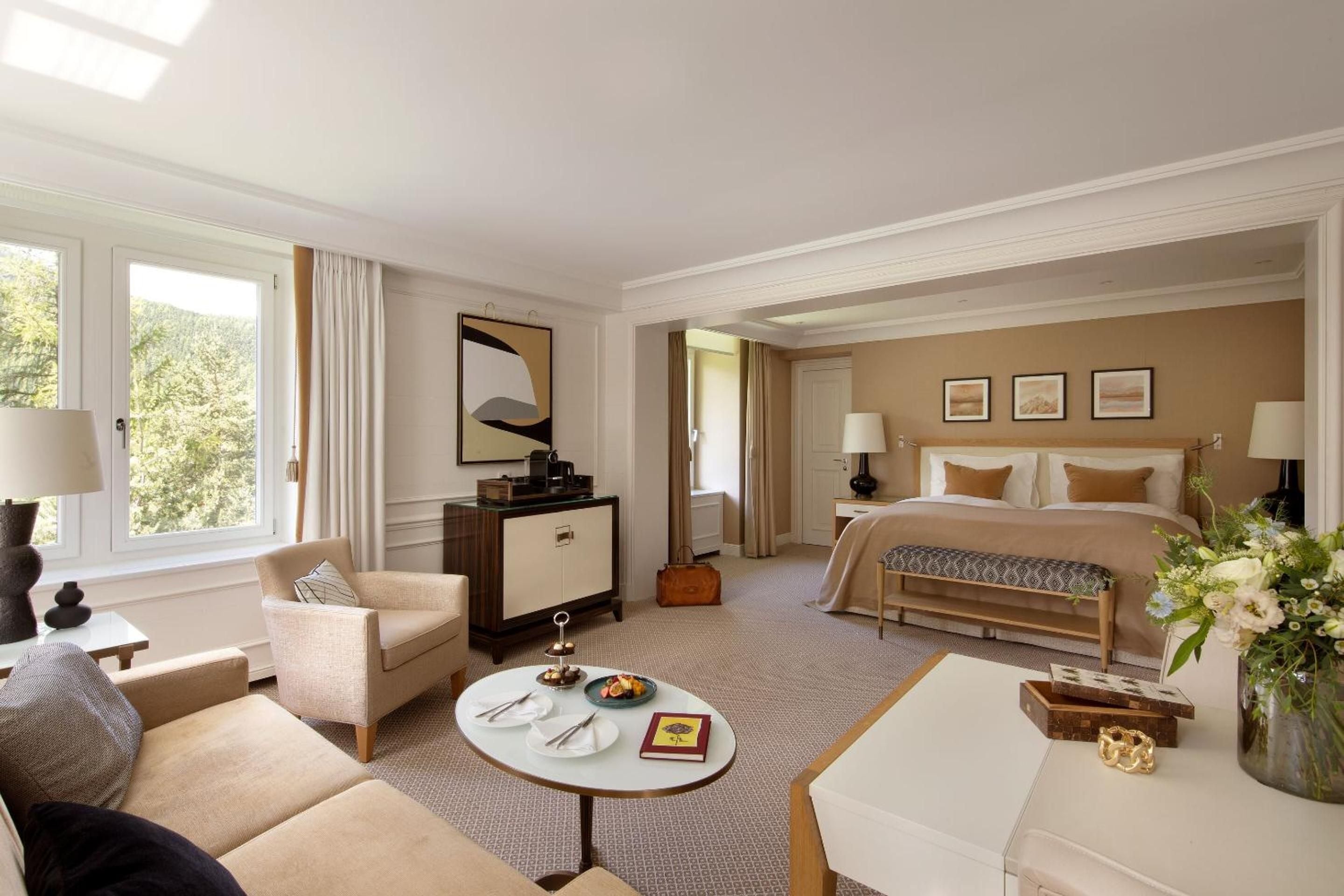 Warm caramel tones and clean Alpine lines define this spacious suite, where morning light filters through generous windows onto honey-hued leather and pristine linens.