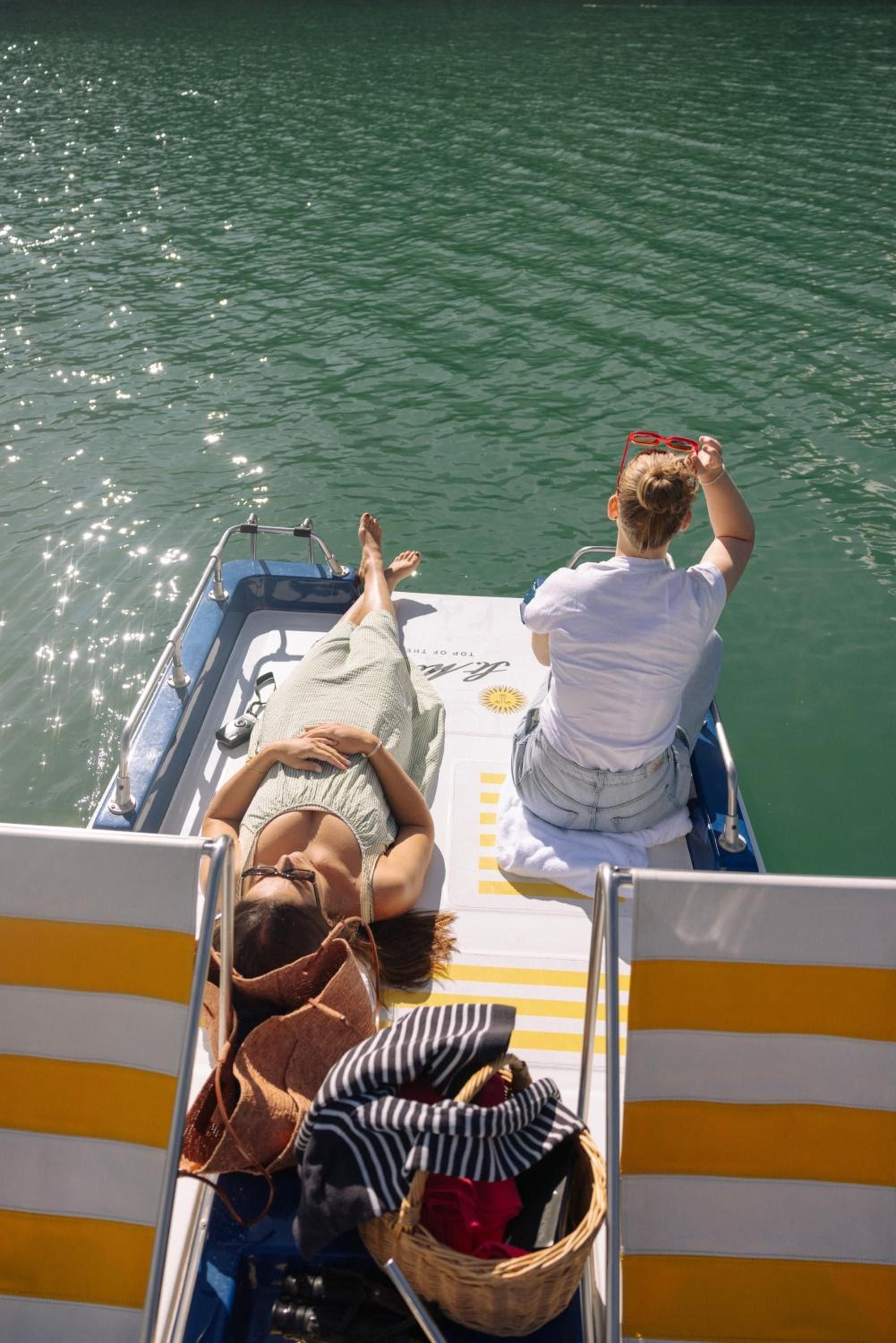 Sun-drenched moments aboard a private vessel reveal the crystalline waters surrounding St. Moritz, where Alpine luxury extends beyond the resort's walls to curated lake excursions.