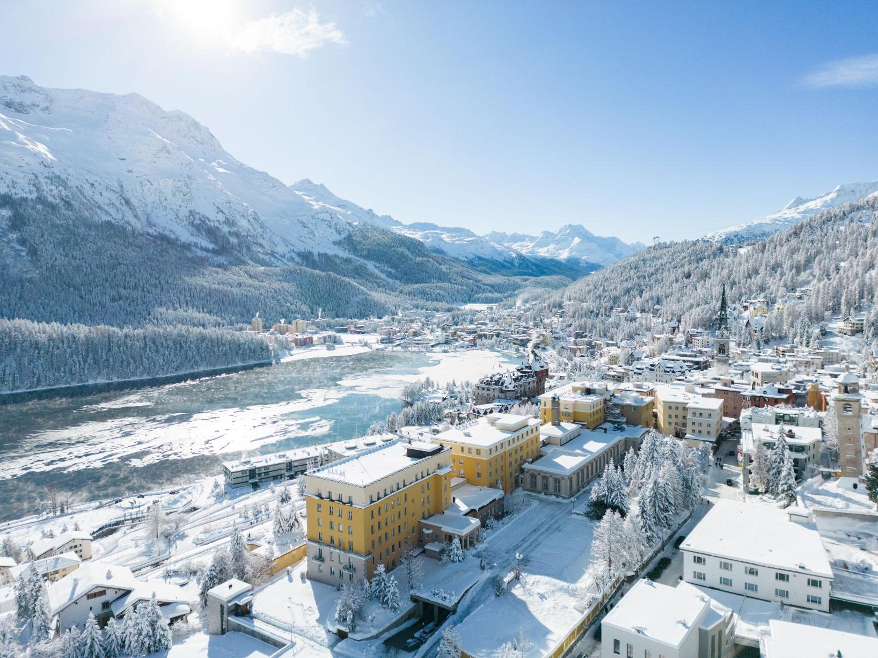 Snow-dusted chalets and grand hotels nestle in St. Moritz's crystalline valley, where Alpine peaks frame Switzerland's most glamorous winter playground in pristine white silence.