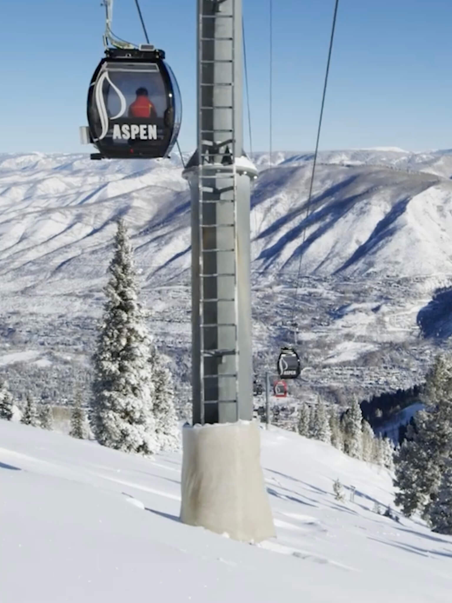Aspen's iconic gondola system whisks guests above snow-draped peaks, offering breathtaking mountain vistas that define this legendary Colorado ski destination's winter allure.