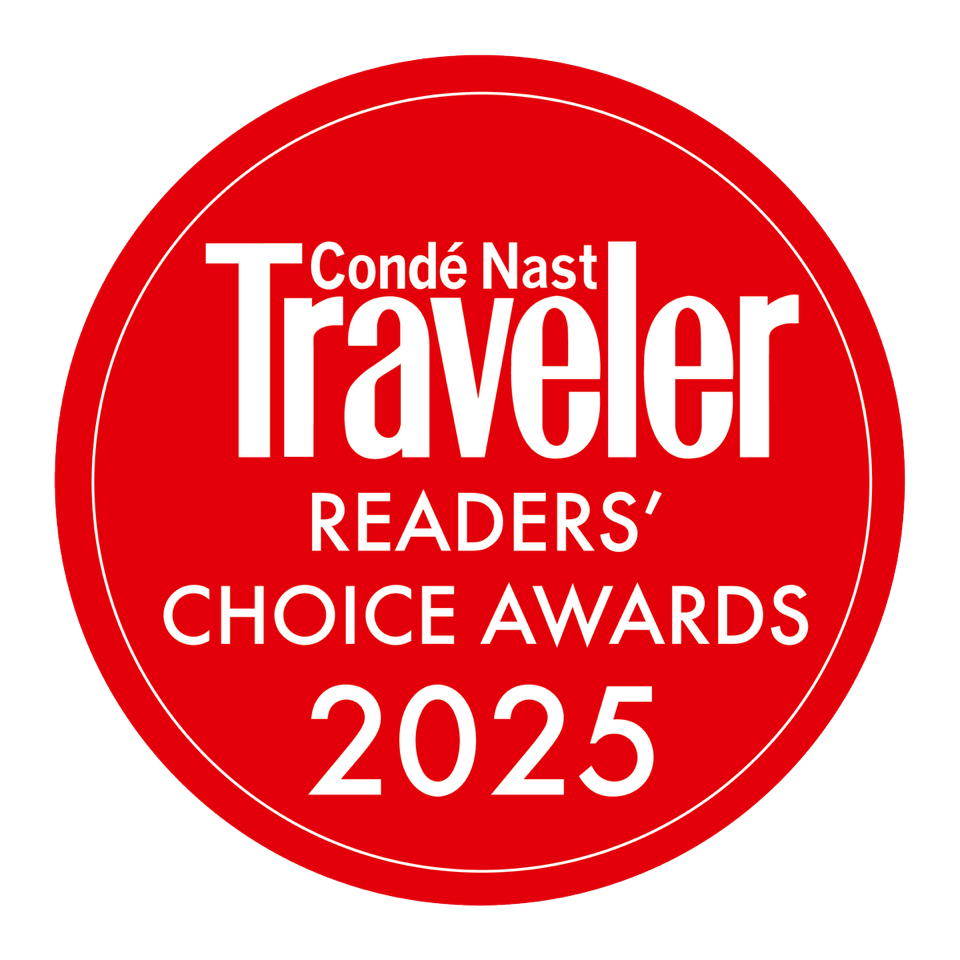 Condé Nast Traveler's prestigious red seal of approval gleams against crisp white typography, marking exceptional hospitality experiences that resonate deeply with discerning readers worldwide.