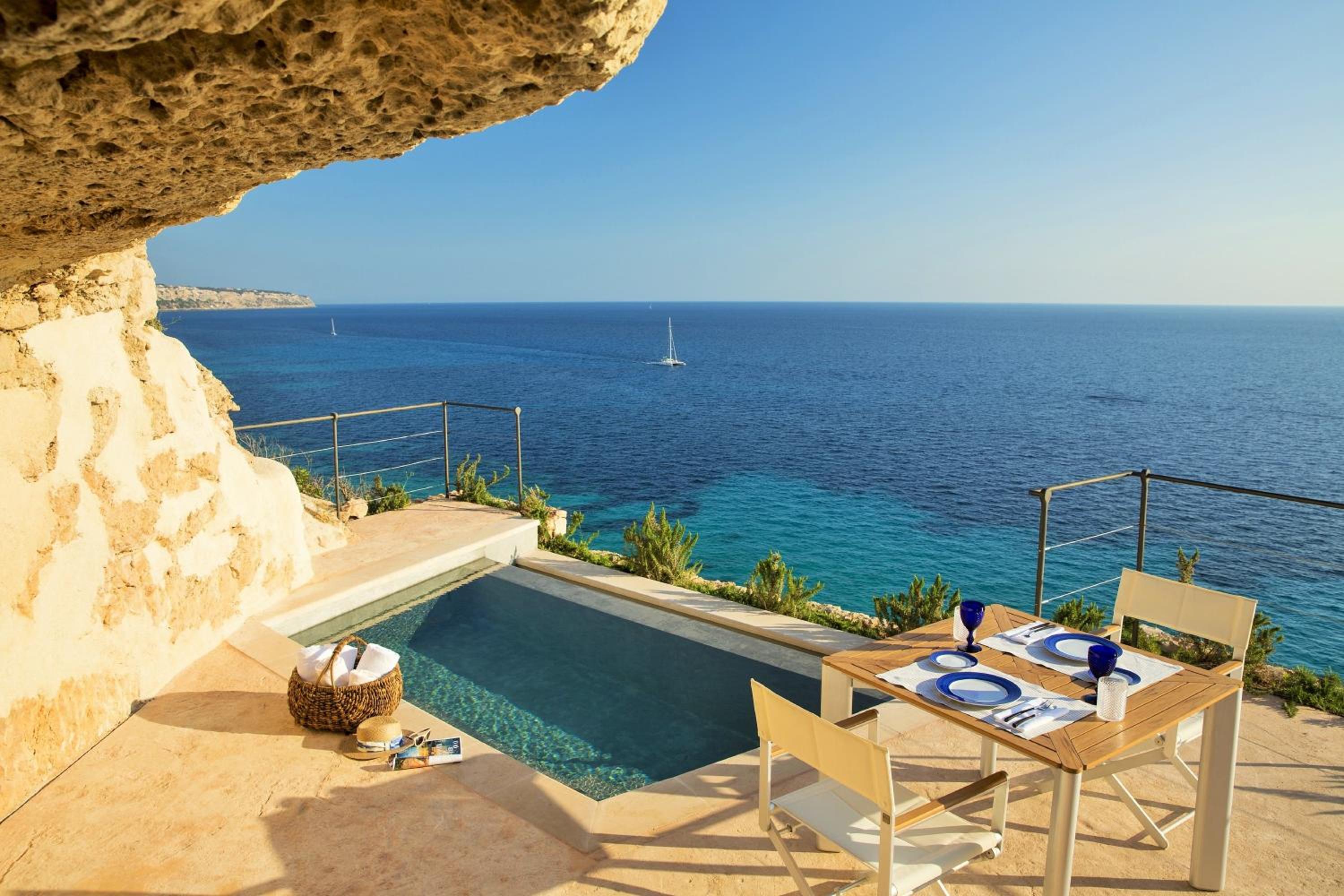 Carved into ancient limestone cliffs, this intimate terrace pool captures the essence of Mediterranean luxury, where turquoise waters mirror the endless Balearic horizon.