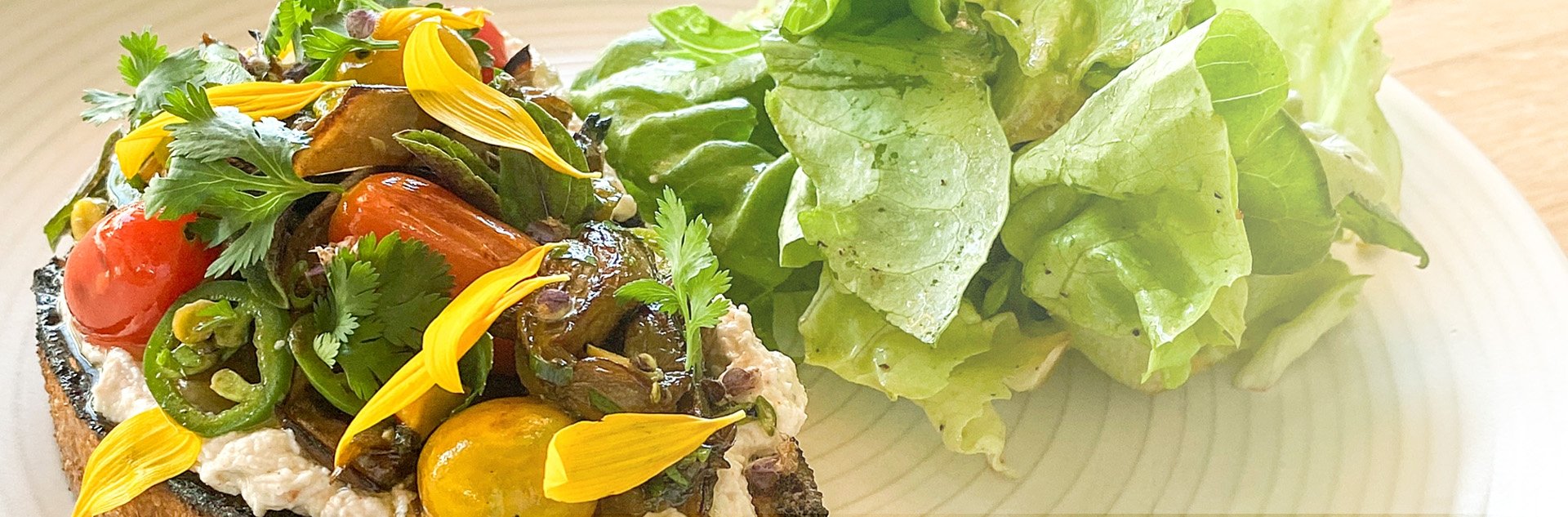 Farm-fresh ingredients shine in artfully composed dishes, where roasted peppers and crisp greens showcase the property's commitment to organic, locally-sourced cuisine.