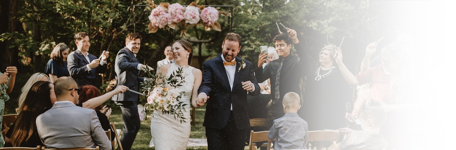 Sunlight filters through cottonwoods as newlyweds celebrate beneath blooming peonies, while guests shower them with petals in the inn's enchanting historic gardens.