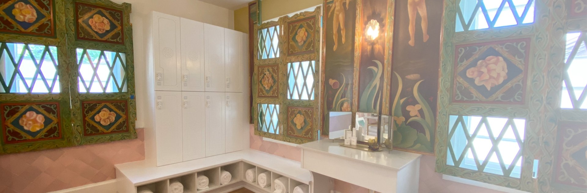 Hand-painted Mexican tiles frame diamond-pane windows in this enchanting bathroom, where Old World craftsmanship meets modern luxury beneath soft natural light.