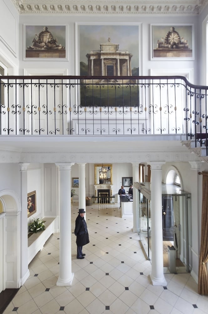 Georgian grandeur unfolds in the soaring entrance hall, where polished marble floors and classical paintings create an atmosphere of refined Dublin elegance.