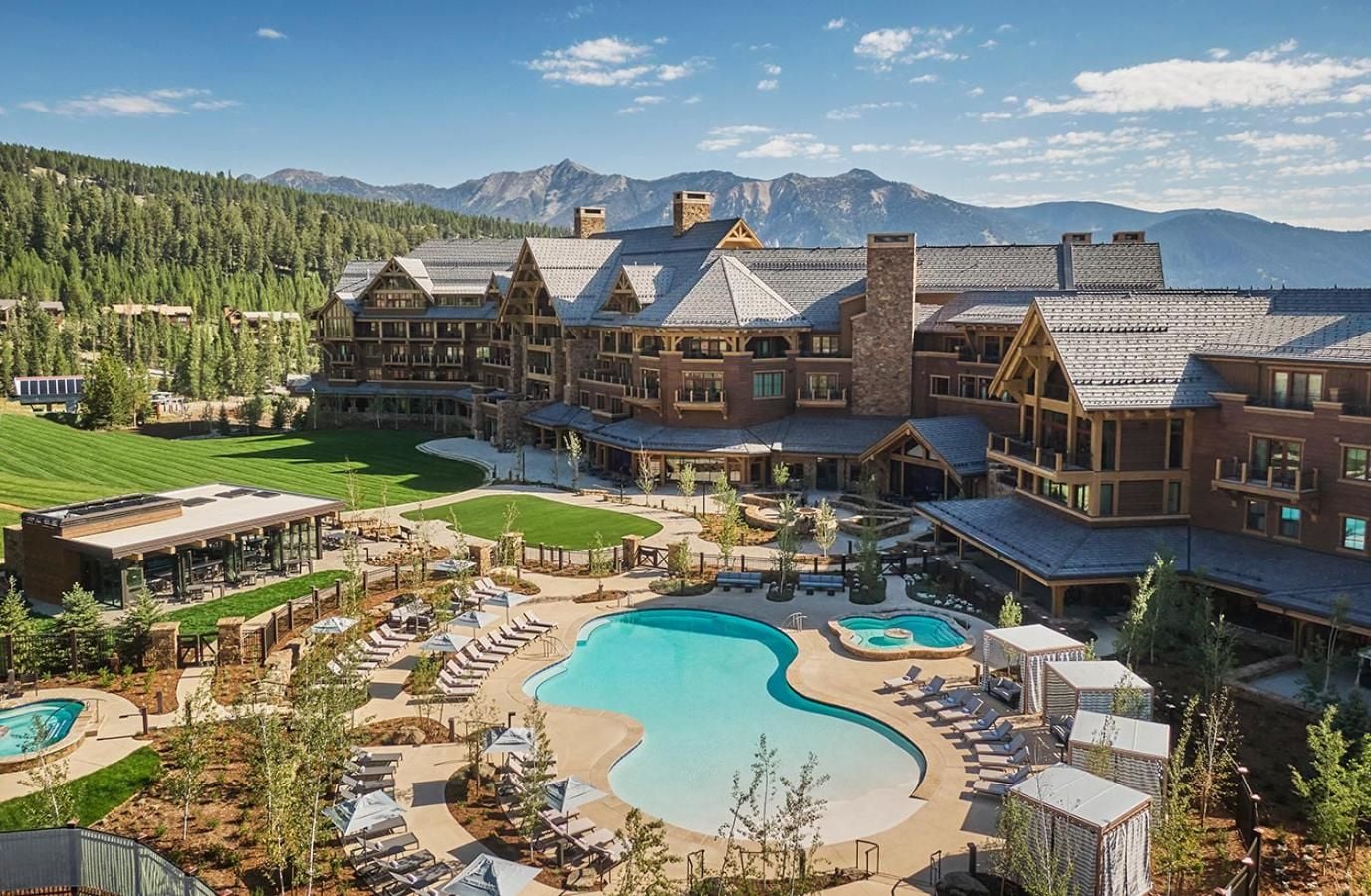 Montana's rugged peaks frame this alpine sanctuary where turquoise pools mirror endless skies and timber-clad lodges promise mountain luxury at every turn.