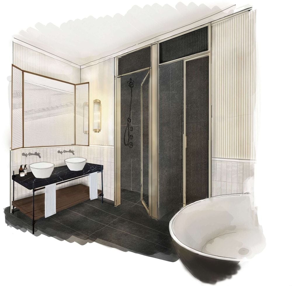 Fluted marble walls and brass fixtures frame the suite's spa-like bathroom, where twin vessel sinks rest on glossy black stone and a sculptural soaking tub commands attention.