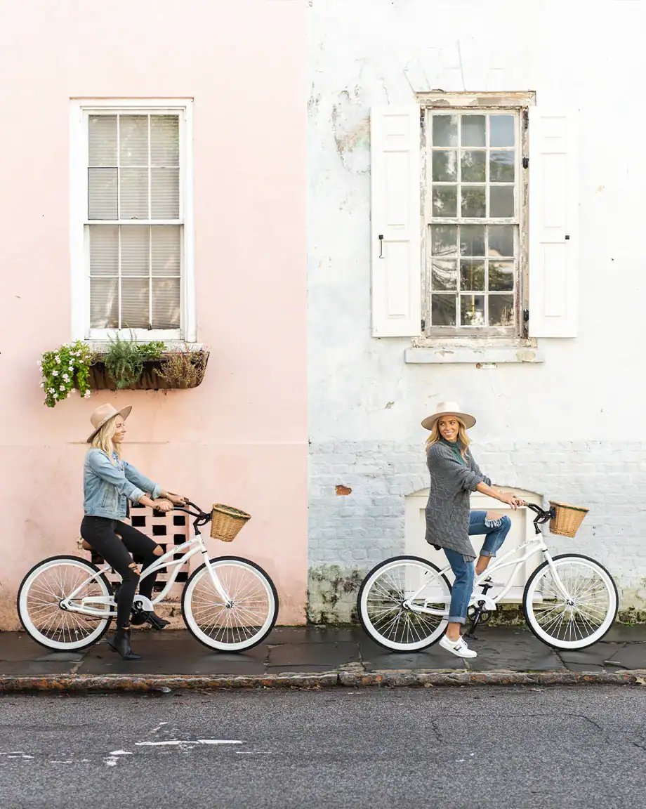 Pastel-painted facades and weathered shutters create a charming backdrop as guests explore the historic neighborhood streets on complimentary vintage bicycles with wicker baskets.