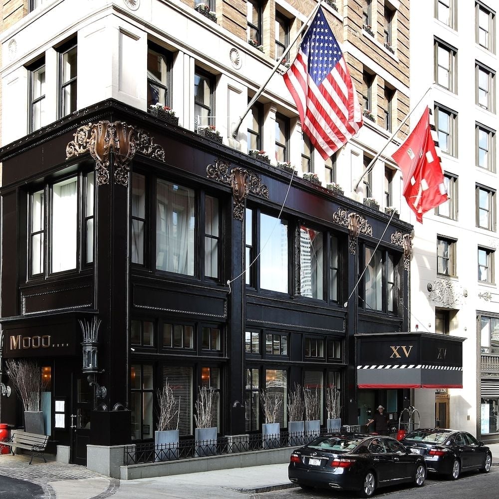 Cast-iron detailing and ornate Victorian architecture create an intimate beacon on Beacon Hill, where American and Canadian flags flutter above cobblestone streets lined with luxury sedans.