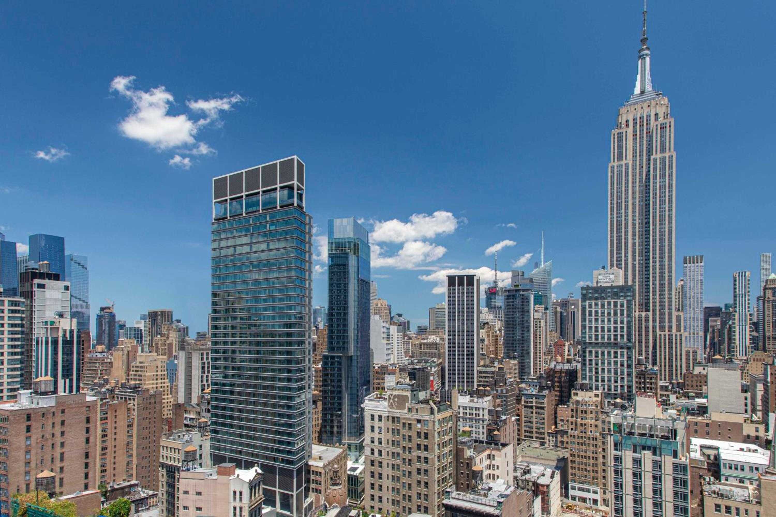 Manhattan's iconic skyline unfolds beyond floor-to-ceiling windows, with the Empire State Building commanding the horizon from this coveted NoMad perch.