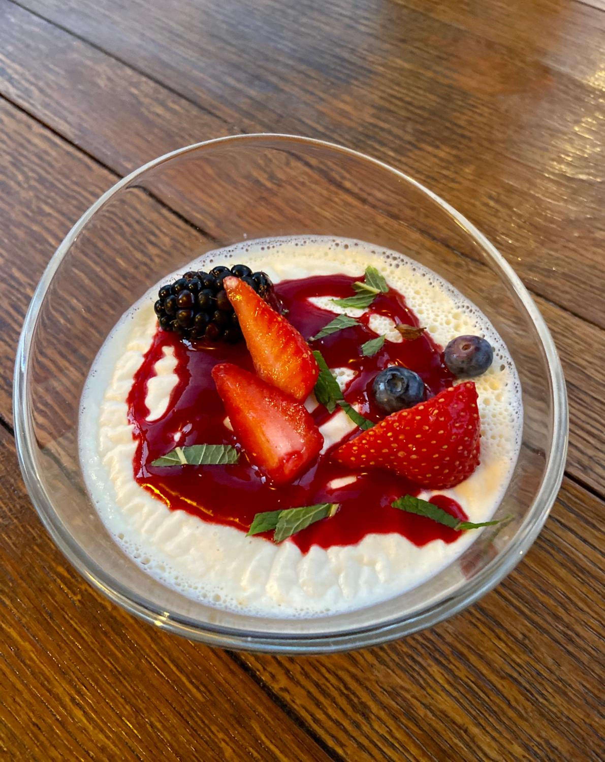 Creamy panna cotta crowned with jewel-toned berries and fresh mint creates an artful finale to lunch on the hotel's sun-dappled terrace.