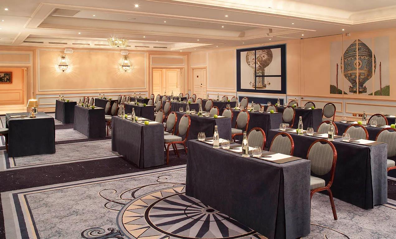 Elegant conference space blends classic French refinement with modern functionality, where ornate ceiling details and warm lighting create an inspiring backdrop for sophisticated gatherings.