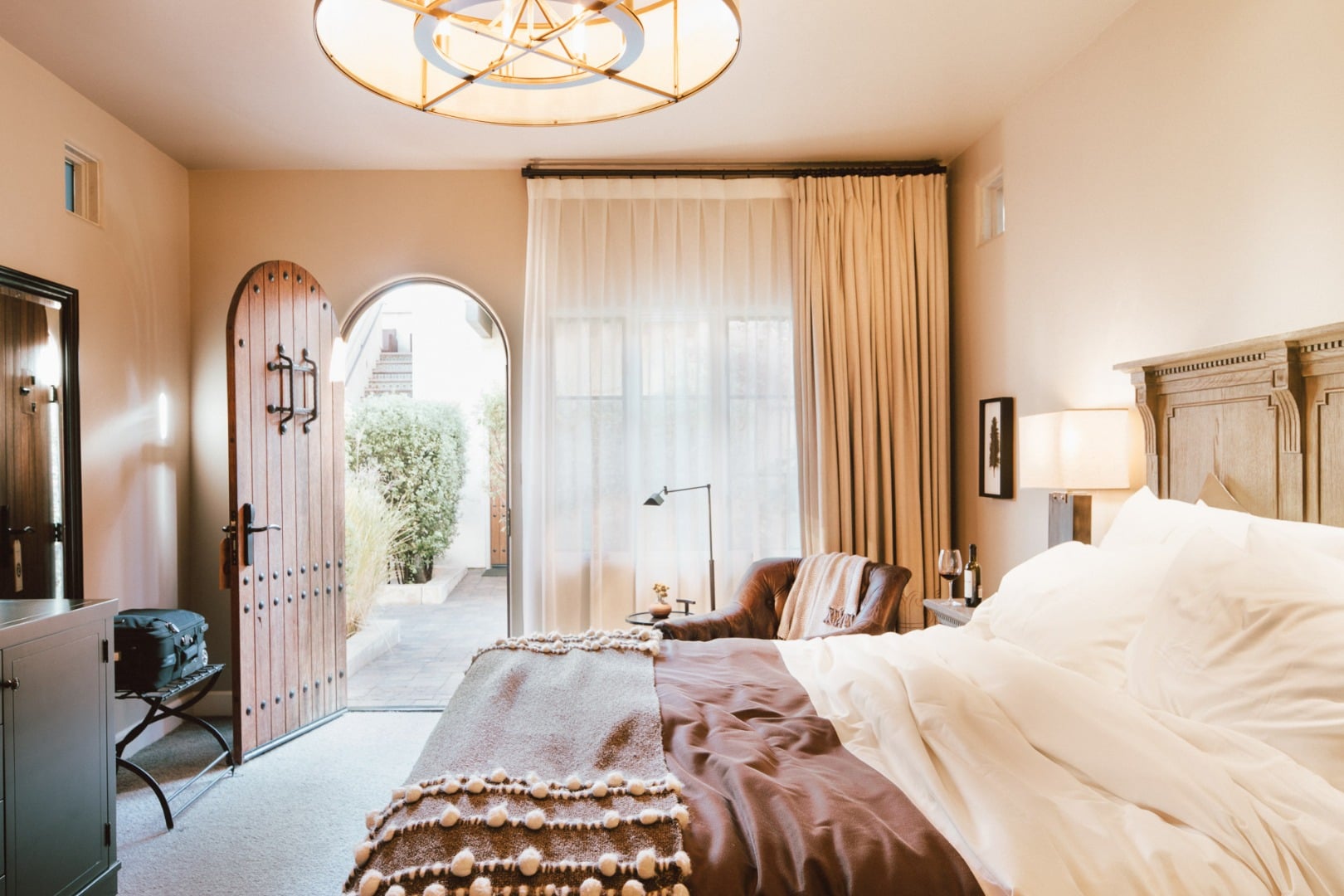 Arched doorways frame Mediterranean light in this serene suite, where terra cotta walls meet handcrafted furnishings and whisper-soft linens invite afternoon siestas.