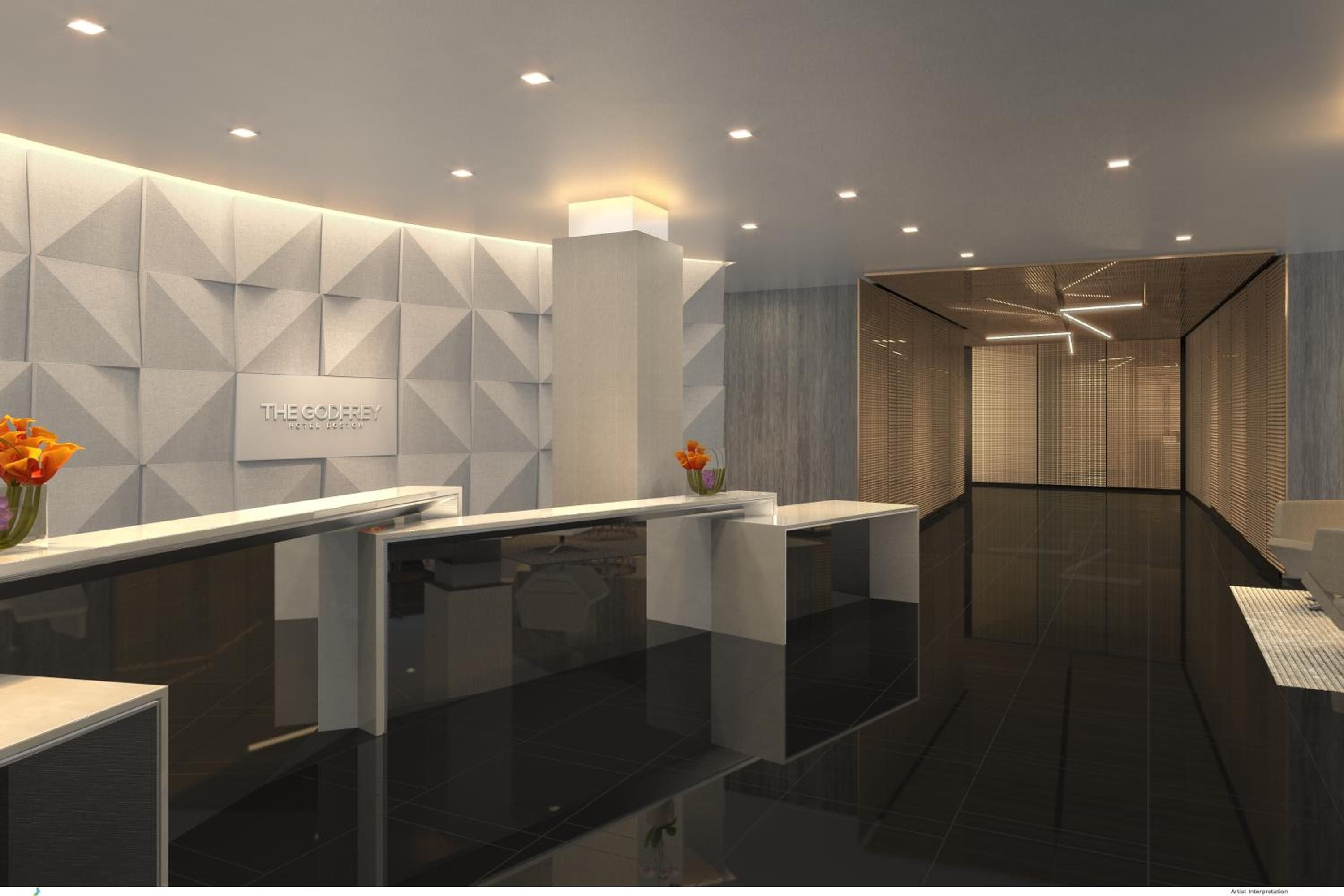 Geometric wall panels and warm amber lighting create an intimate check-in experience, where sleek marble counters meet sophisticated bronze accents in this thoughtfully designed reception space.