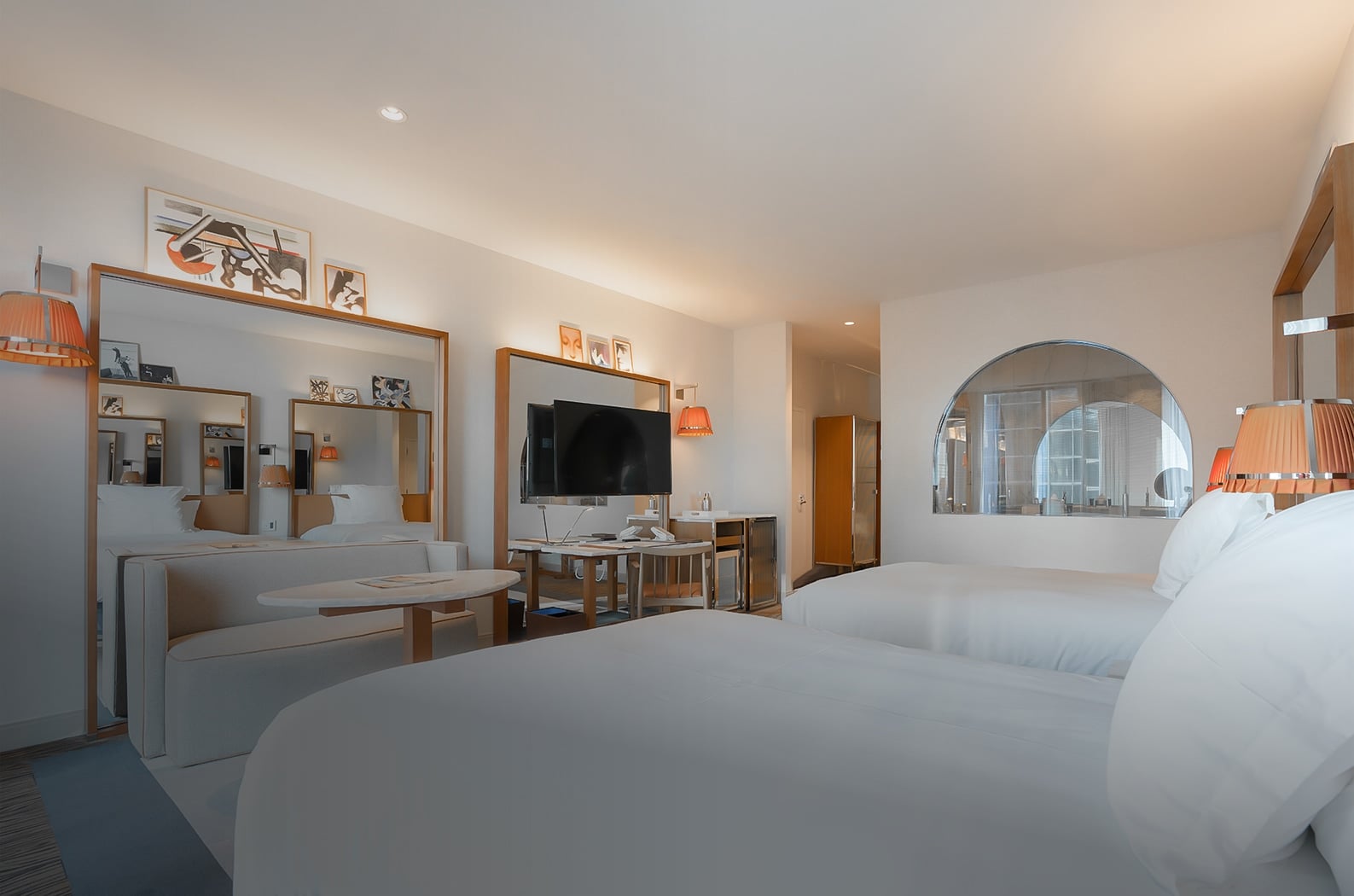 Crisp white linens contrast beautifully with warm wood accents and amber pendant lights, creating an inviting sanctuary high above downtown Seattle's bustling streets.