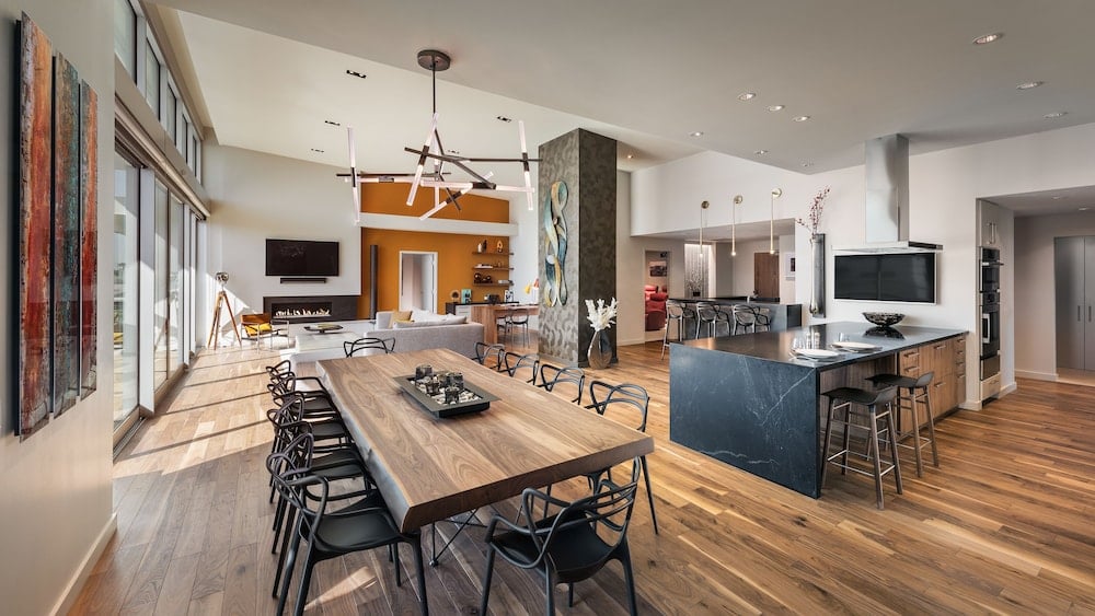Sunlight streams across rich walnut floors in this sprawling suite, where desert-modern design meets sophisticated comfort through sleek furnishings and an open-concept layout.