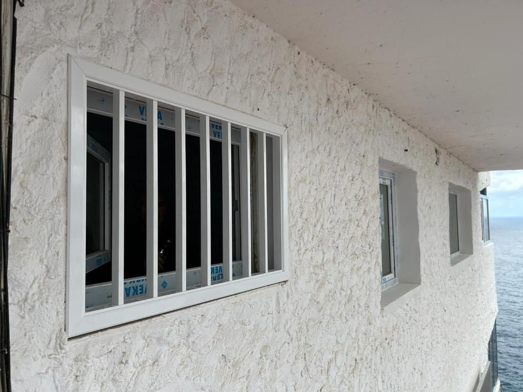 White-washed walls and traditional barred windows frame endless ocean vistas from this clifftop perch, where Mediterranean architecture meets Atlantic drama.