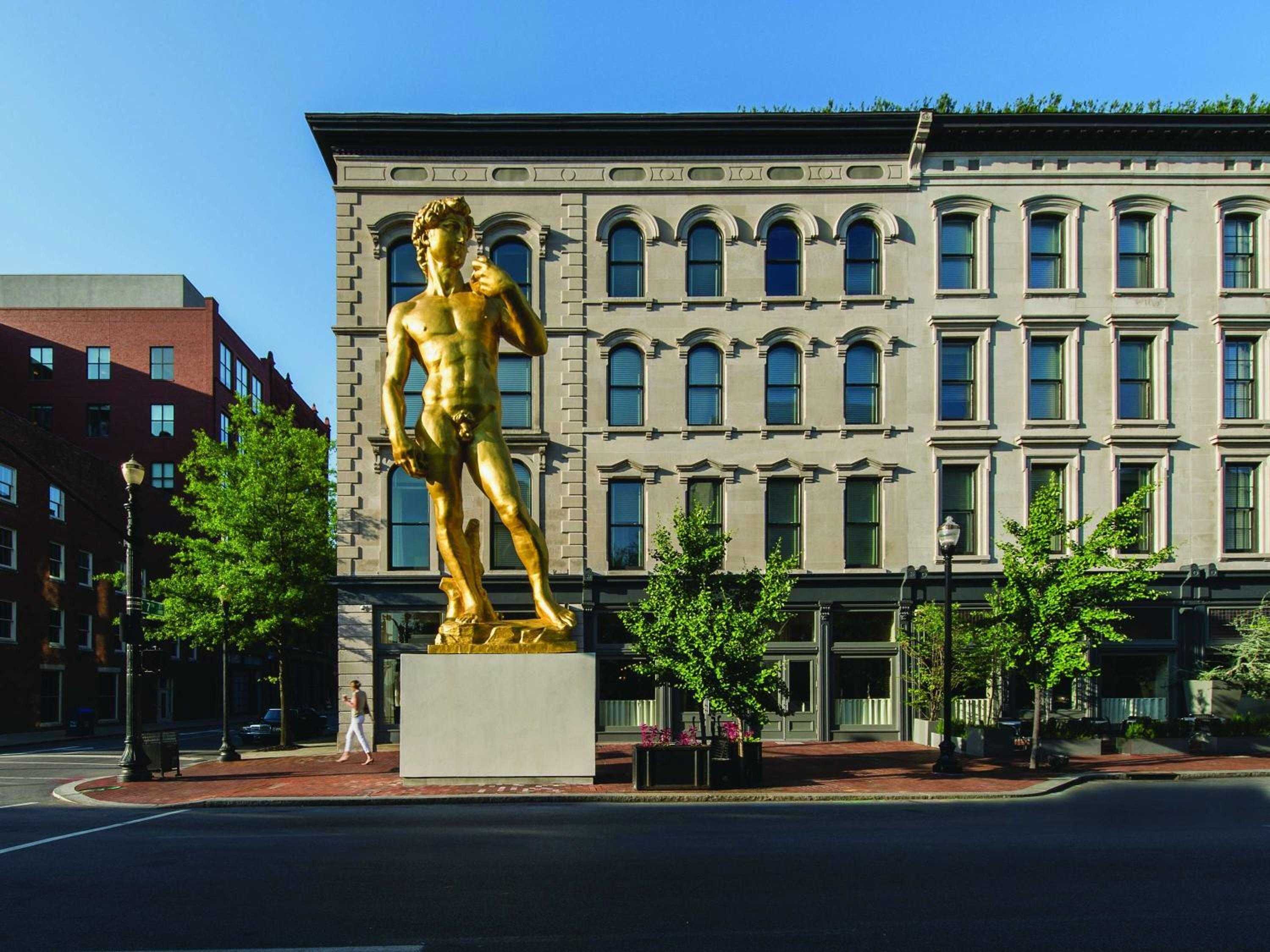 Michelangelo's golden David commands Louisville's historic streetscape, where Renaissance artistry meets contemporary hospitality in this boldly curated museum hotel's striking outdoor gallery.