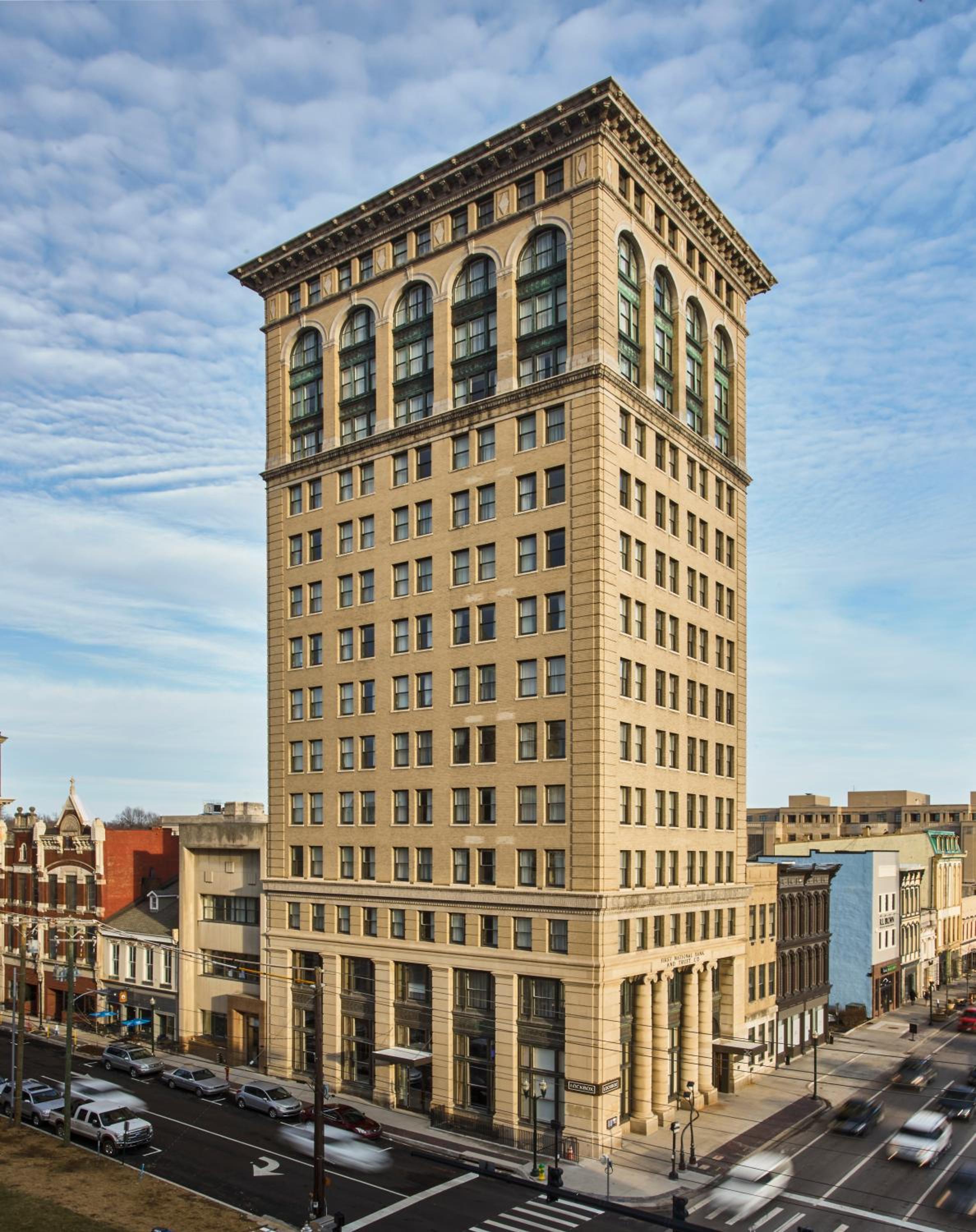 Limestone façade and arched windows crown this restored 1913 banking hall, where Beaux-Arts grandeur meets contemporary hospitality in downtown Lexington's cultural heart.