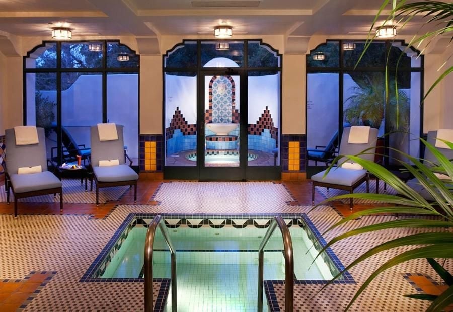 Moroccan-inspired tilework and warm lanterns frame this intimate spa sanctuary, where an inviting plunge pool beckons beneath coffered ceilings and desert twilight.