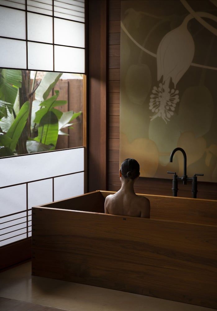 Soaking in the hinoki wood ofuro tub while soft shadows dance across shoji screens creates an intimate sanctuary where Hawaiian tranquility meets Japanese ritual.