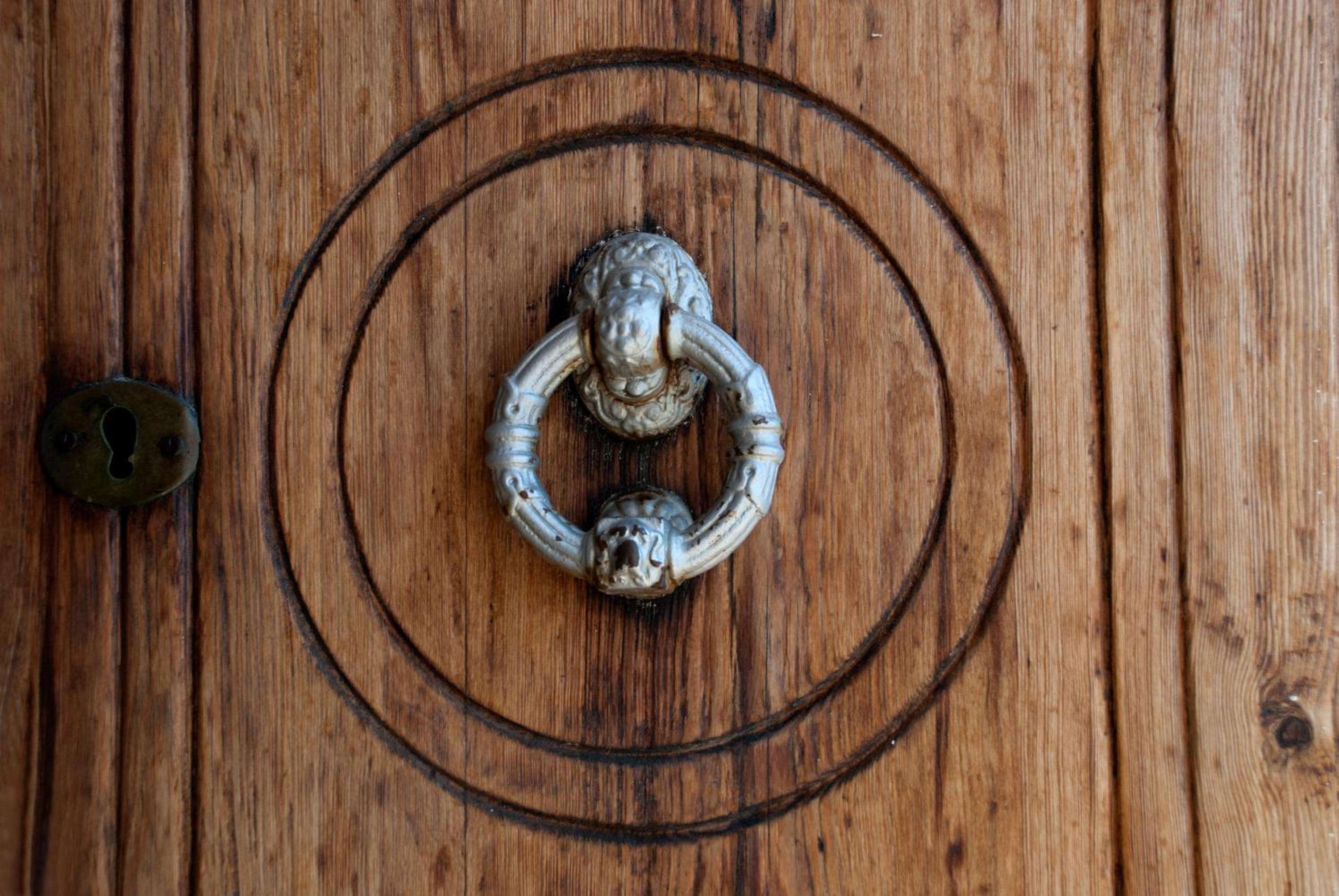 Weathered brass door knocker bears the patina of centuries on Son Bunyola's original wooden doors, where every surface tells stories of Mallorca's storied past.