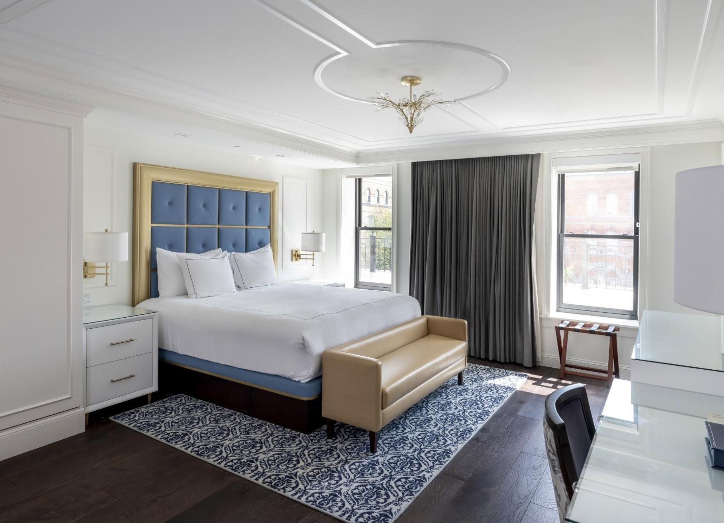 Sophisticated blues and golds create an elegant sanctuary, where tufted leather seating and intricate ceiling moldings frame windows overlooking Saratoga's historic streetscape.