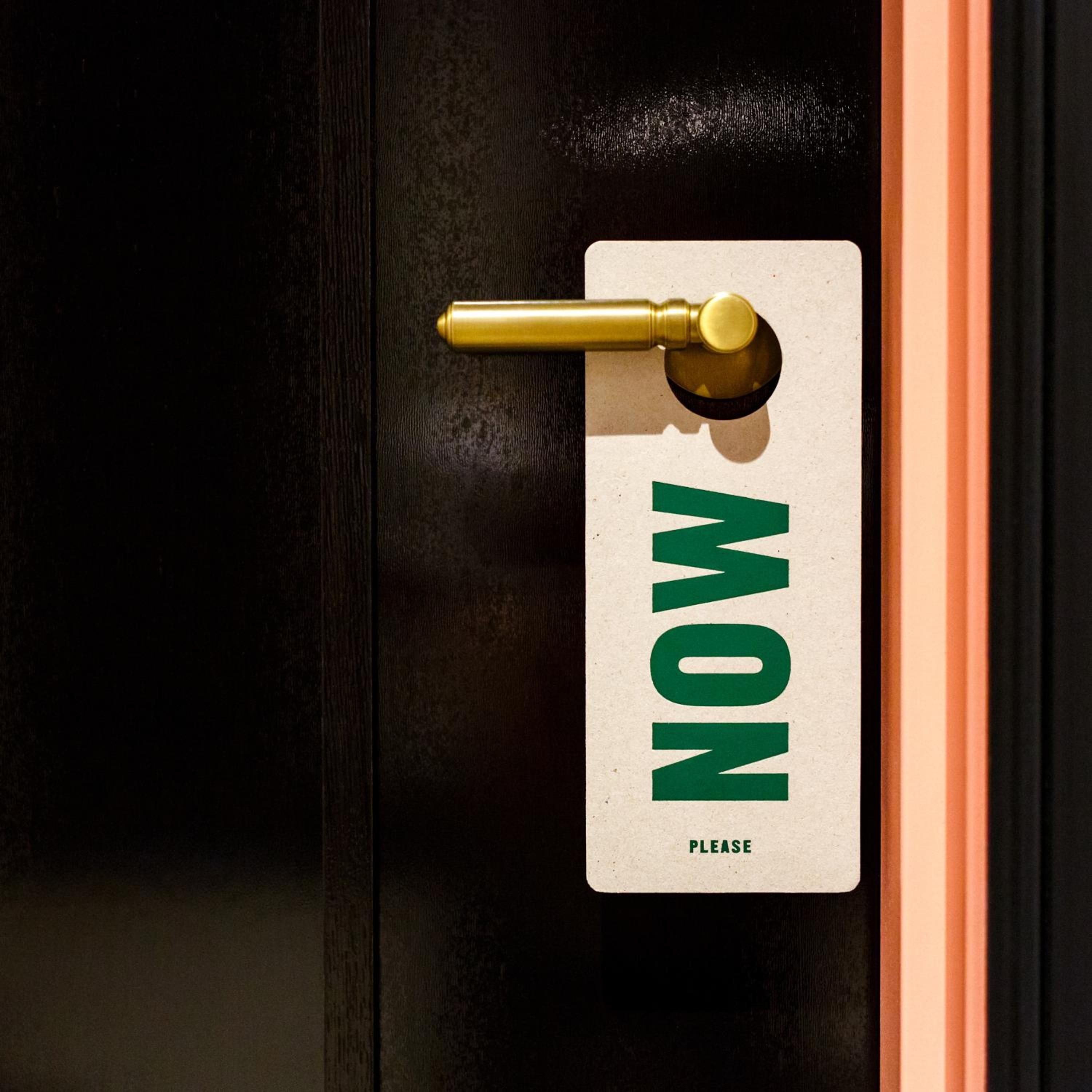 Burnished brass hardware and thoughtful typography create moments of quiet luxury, where even the simplest gesture speaks to considered design and gracious hospitality.