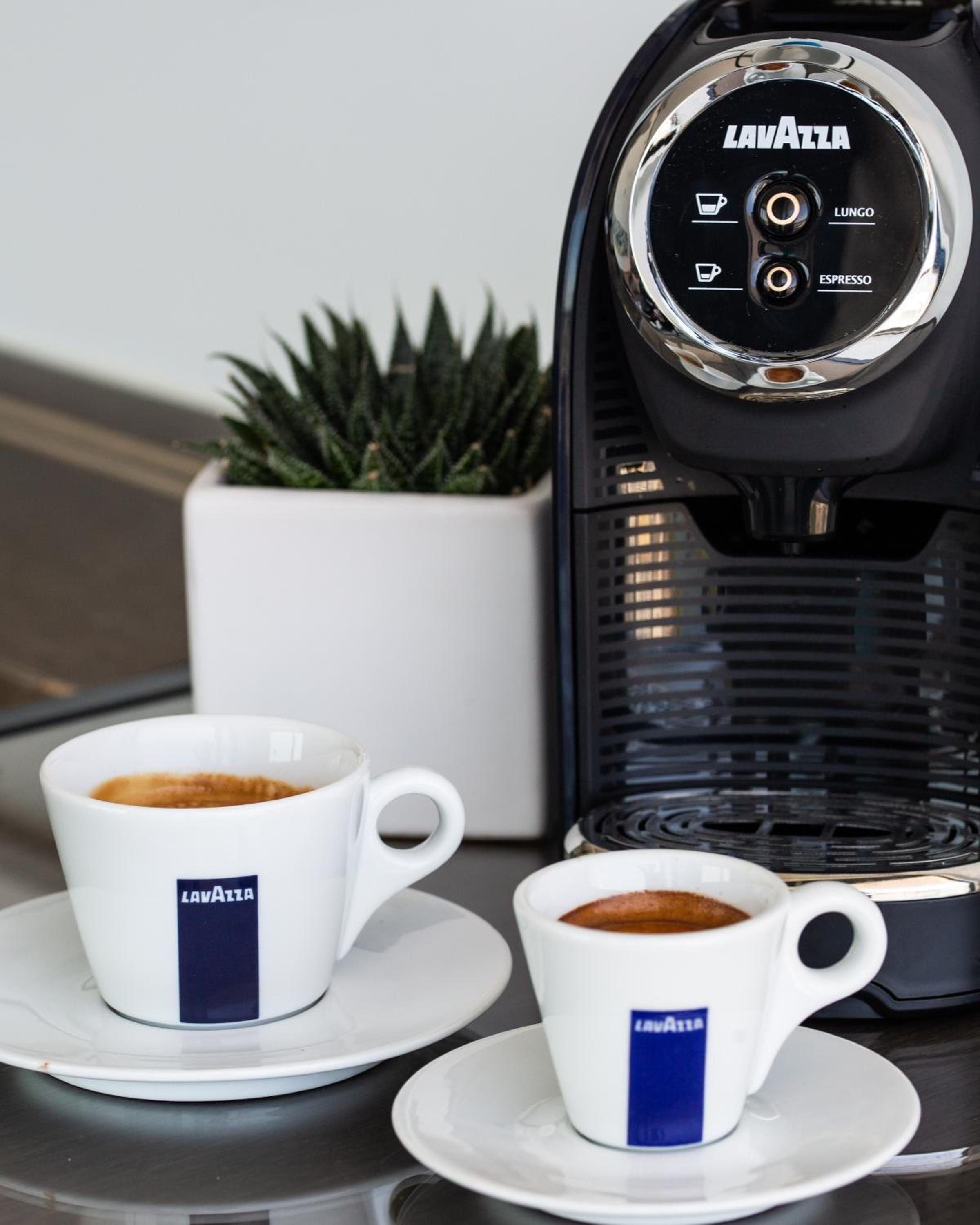 Lavazza espresso service brings Italian café culture to your suite, with perfectly crafted cups and sleek chrome details creating an intimate coffee ritual.